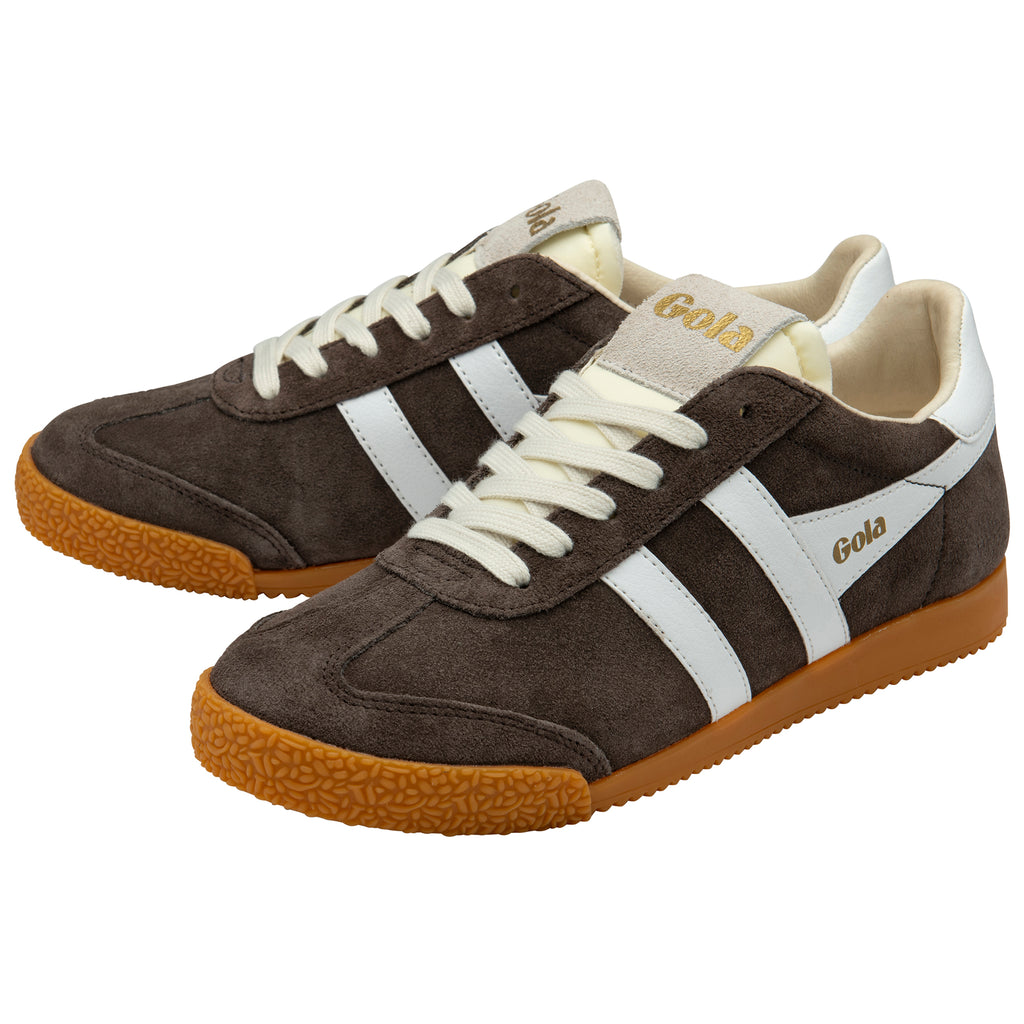 Pair of brown trainers with white laces and soles on a white background