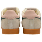 Pair of beige trainers with brown soles on a white background