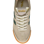 Beige trainer with white laces and green stripe on a white background