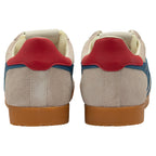 Pair of beige trainers with red and blue accents on a white background