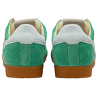 Green trainer with brown soles on a white background