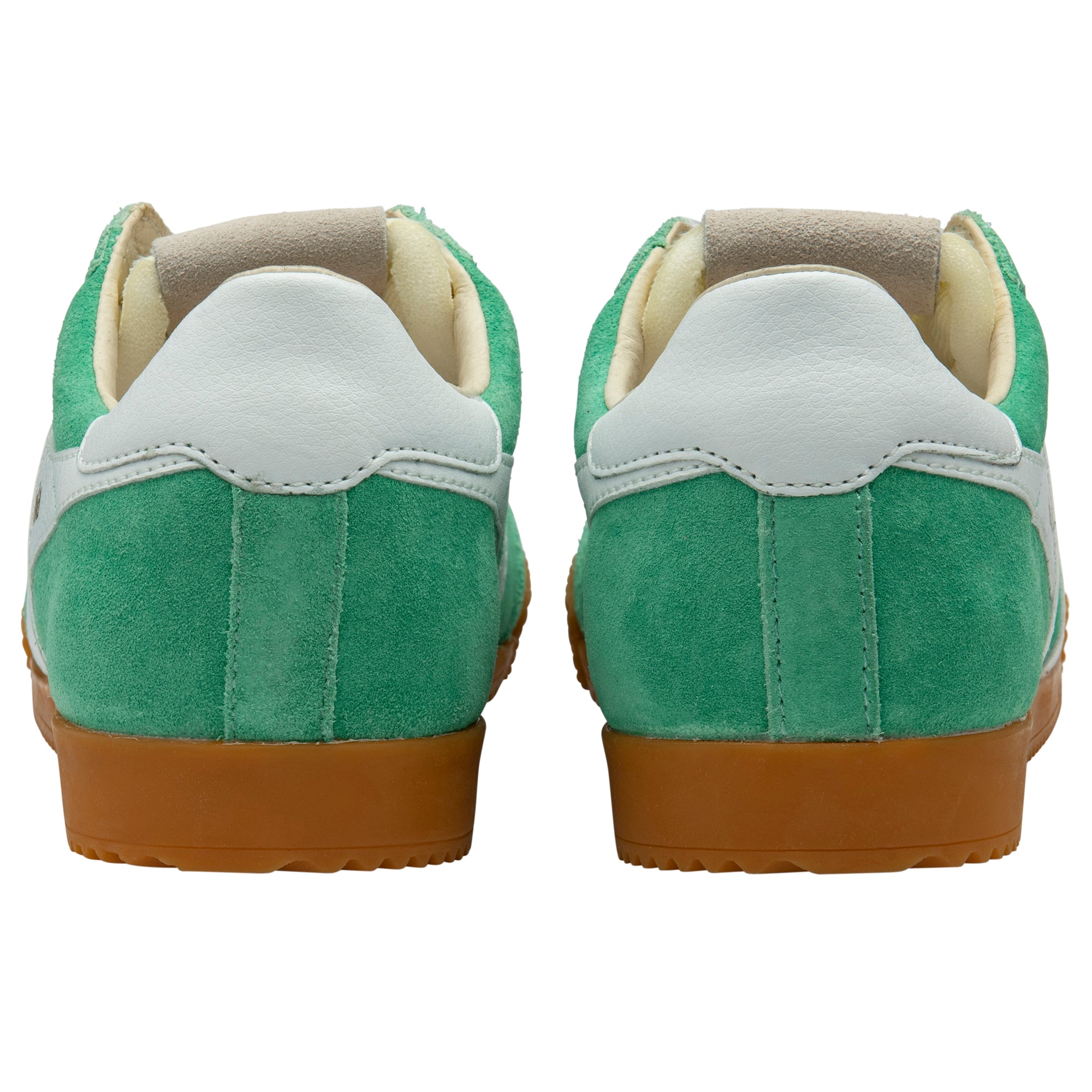 Green trainer with brown soles on a white background
