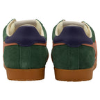 Green trainers with blue accents on a white background
