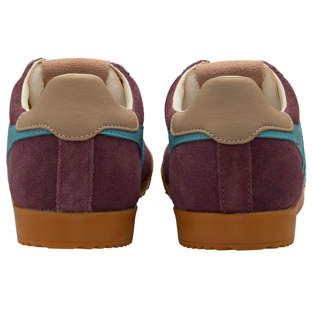 Pair of maroon trainers with brown soles and beige accents on a white background