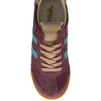 Maroon trainer with blue stripes and tan laces on a white background