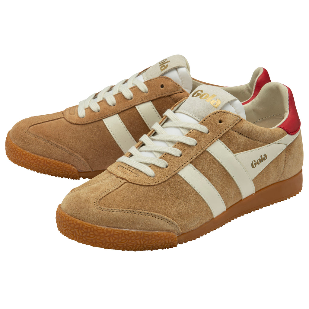 Pair of tan trainers with white stripes and red accents on a white background