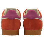 Pair of orange trainers with purple heel on a white background