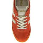 Orange trainer with white laces on a white background