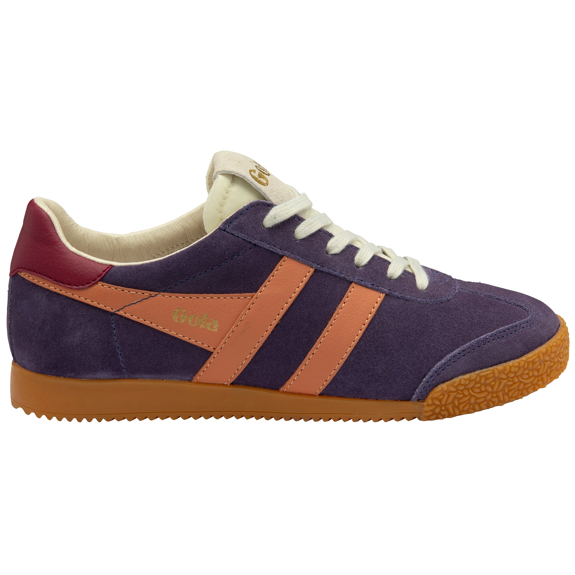 Purple trainers with orange accents and white laces on a white background