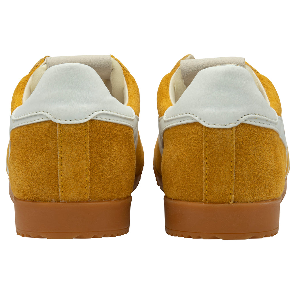 Pair of yellow trainers with white soles on a white background