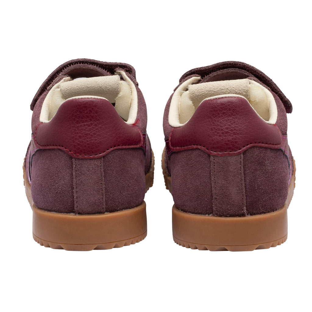 Pair of burgundy suede trainers with brown soles, rear view