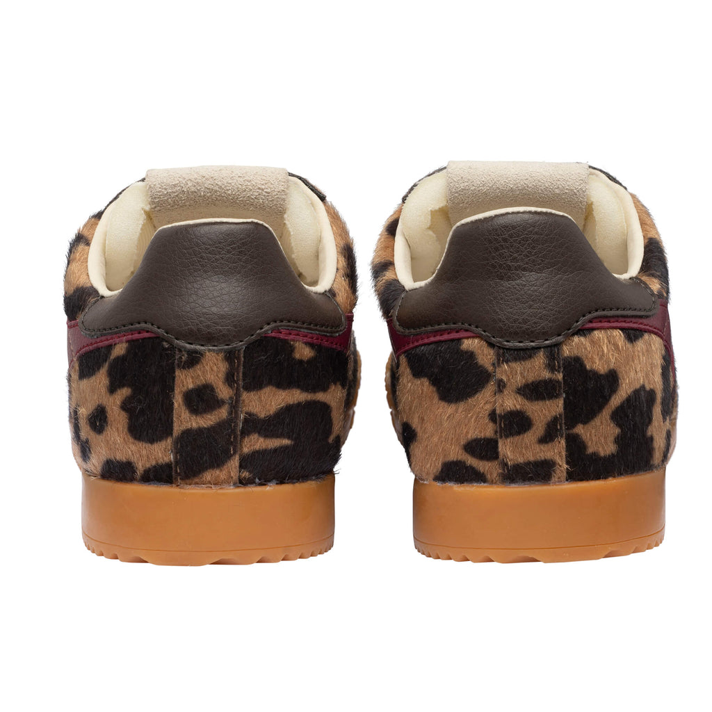 Pair of leopard print trainers with brown leather heel tabs and gum soles
