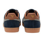 Pair of navy blue suede trainers with tan leather accents and gum soles, rear view