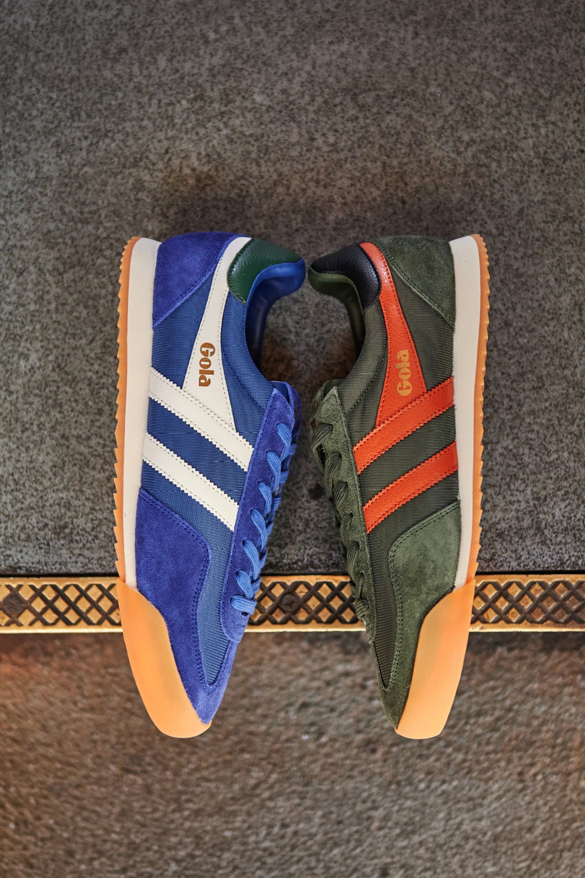 Blue and green Gola Harrier trainers with orange soles