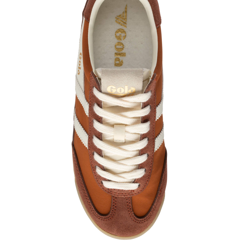 Top-down view of a Gola Harrier trainer in tan with white stripes and laces