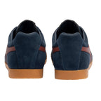 Rear view of two navy blue suede trainers with brown stripes and gum soles