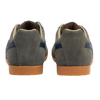 Pair of green suede trainers with blue stripes and tan soles, rear view