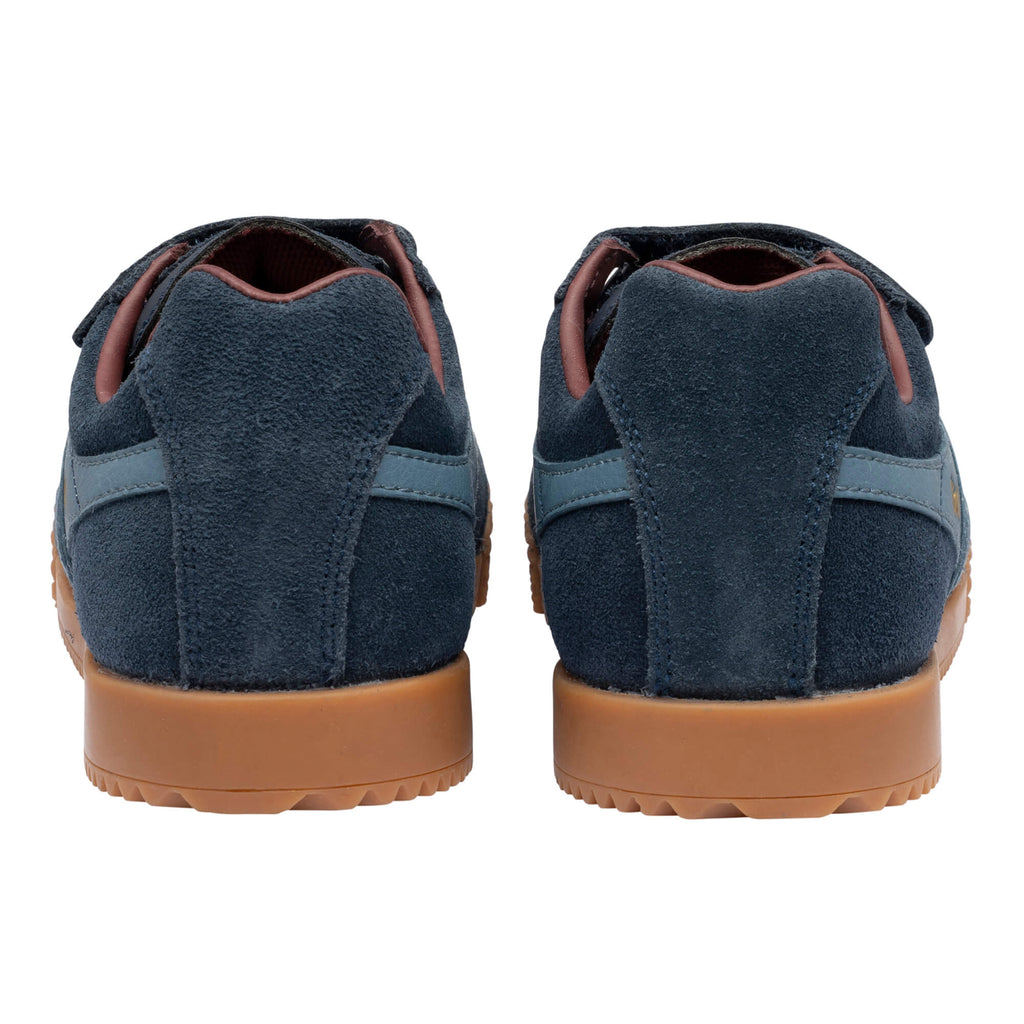 Pair of navy blue suede trainers with brown soles, rear view