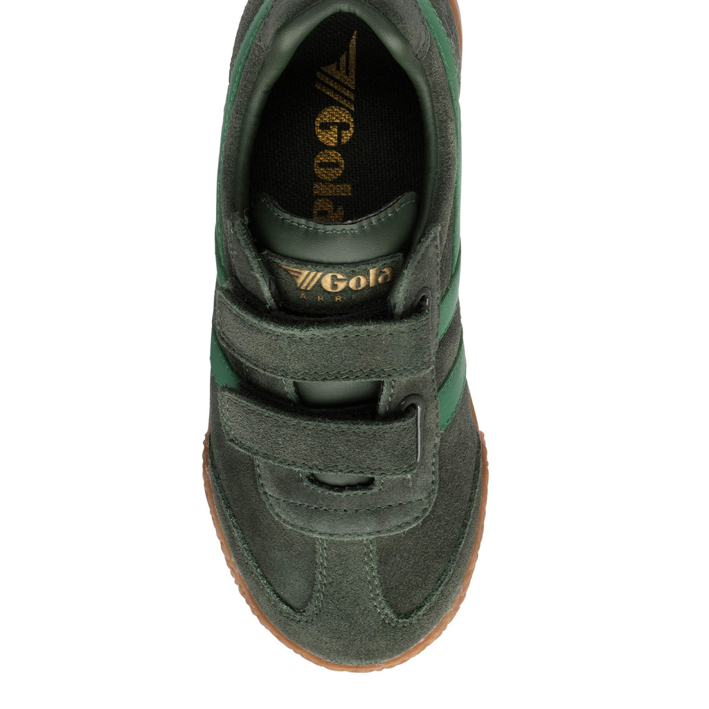 Top-down view of a dark green suede trainer with two hook-and-loop straps and a gum sole