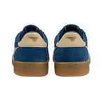 Pair of blue suede trainers with beige heel tabs and gum soles, rear view