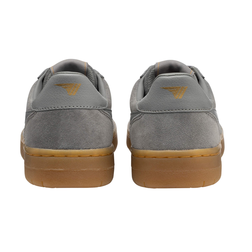 Rear view of two grey suede trainers with tan soles and a gold logo on the heel