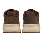 Pair of brown suede trainers with cream soles, rear view
