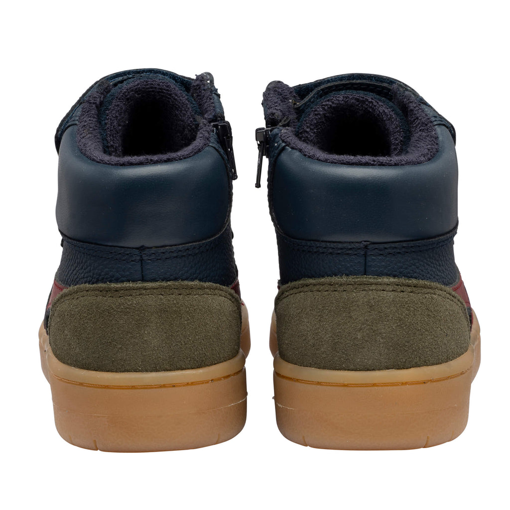 Rear view of two navy blue and olive green high-top trainers with tan soles