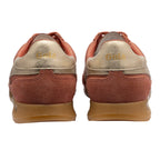 Rear view of two Gola trainers in rust and gold with gum soles