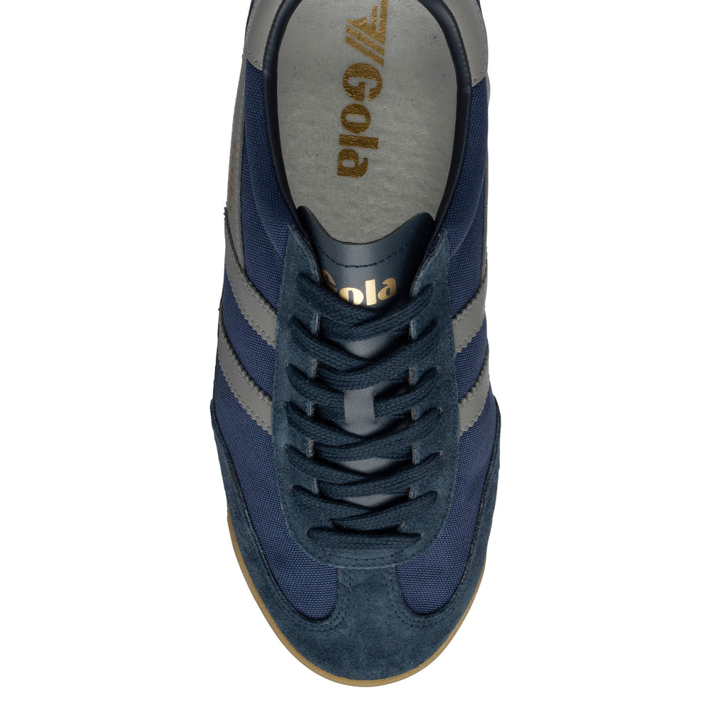 Overhead view of a navy blue Gola trainer with grey stripes and a brown sole