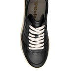 Black Gola trainer with cream laces and sole, top-down view