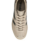 Top-down view of a Gola Harrier trainer in beige suede with dark green stripes and a brown heel tab