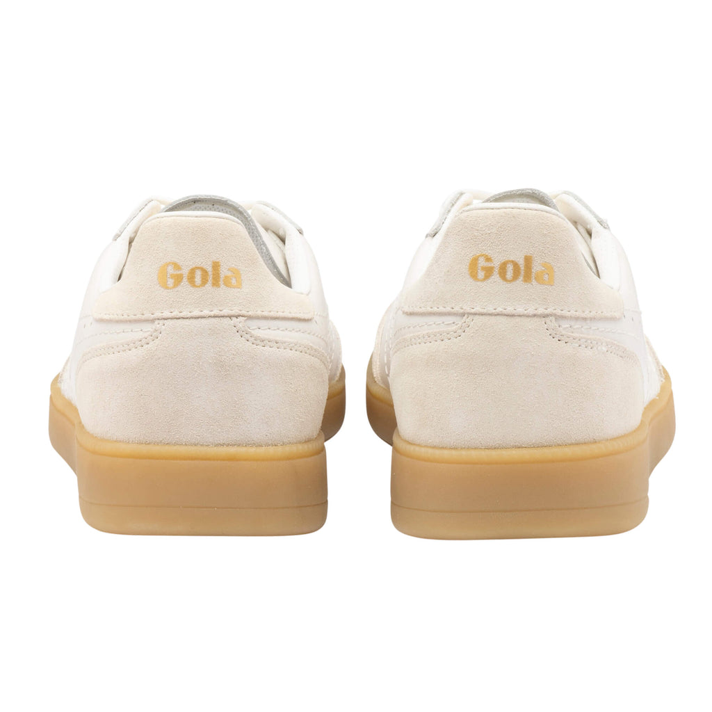 Rear view of two Gola trainers, off-white with a gum sole and gold Gola branding on the heel