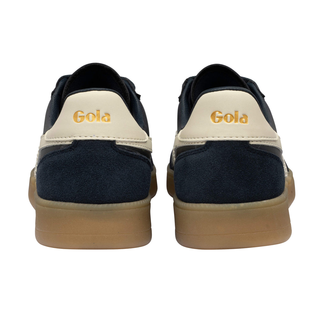 Rear view of two navy Gola trainers with cream heel tabs and gum soles